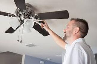 Electricians working on ceiling fan
